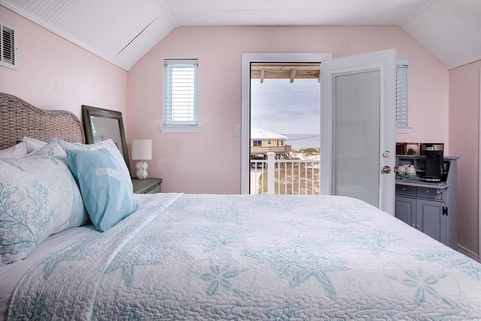Queen bedroom with coffee station and door to a private deck