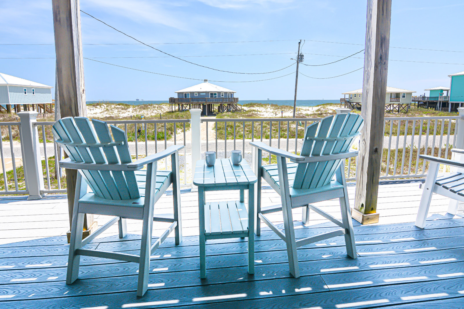 Gulf view from a deck at Jellyfish Twist with Adirondack chairs